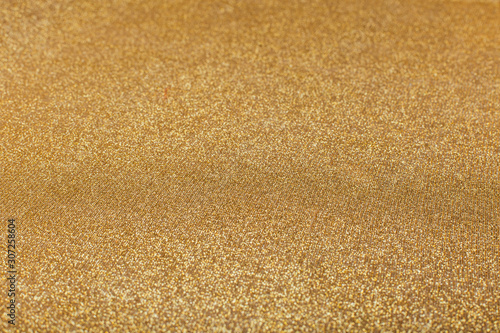 Abstract blurred gold sparkle bakground.