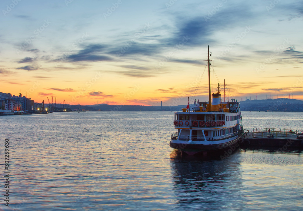 Bosphorus strait with ferry boats on the sunset in Istanbul
