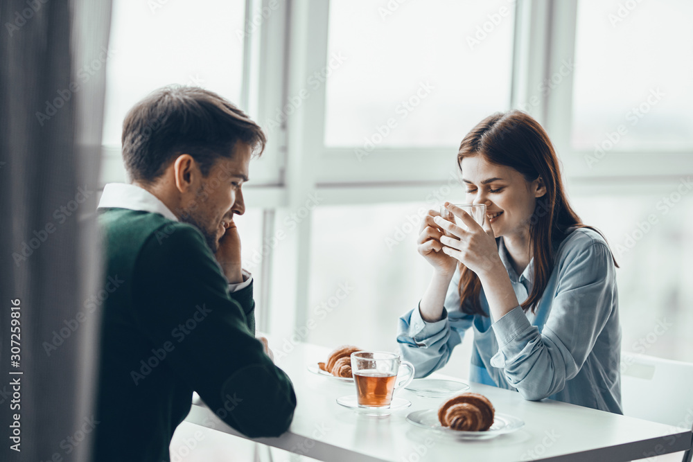young couple having breakfast in the kitchen young couple having breakfast in the kitchen