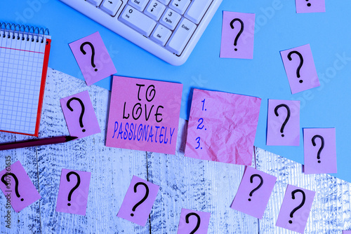 Handwriting text To Love Passionately. Conceptual photo Strong feeling for someone or something else Affection Writing tools, computer stuff and math book sheet on top of wooden table