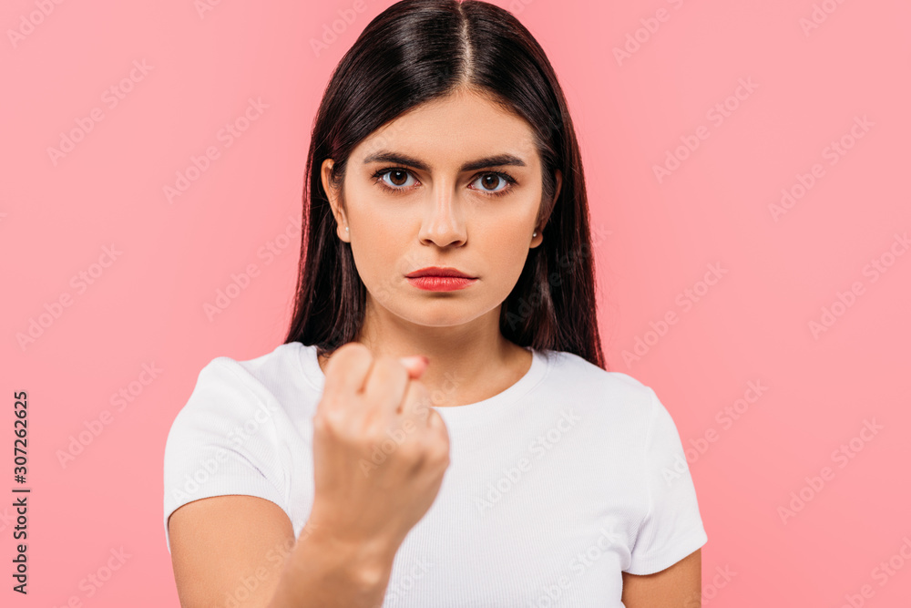 Φωτογραφία angry pretty brunette girl showing fist isolated on pink