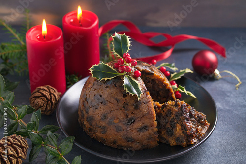 Christmas pudding decorated with sprig of holly. Cristmas decorations