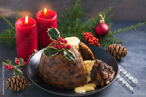 Christmas pudding decorated with sprig of holly. Cristmas decorations