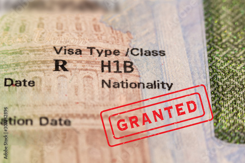 Granted stamp on passport visa page. H1-B is temporary work visa for foreign skilled workers in specialty occupation for doctors, engineers, nurses, statistics etc. Fragment stamp. 