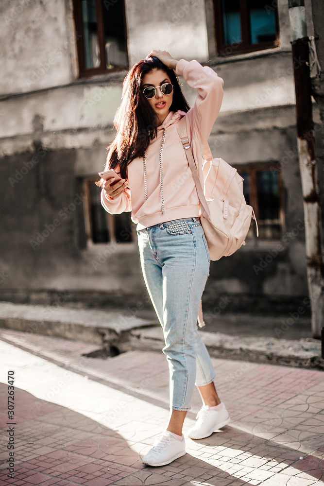 Beautiful model posing for the camera on the streets. Beautiful model posing for the camera on the streets.