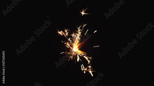 Close-up of firework sparkler burning. Fireworks burn on a black background. Slow motion shot photo