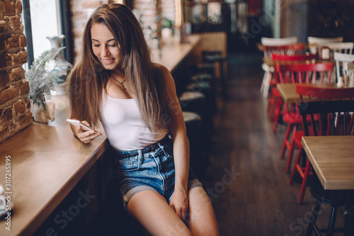Woman using phone in a cafe.