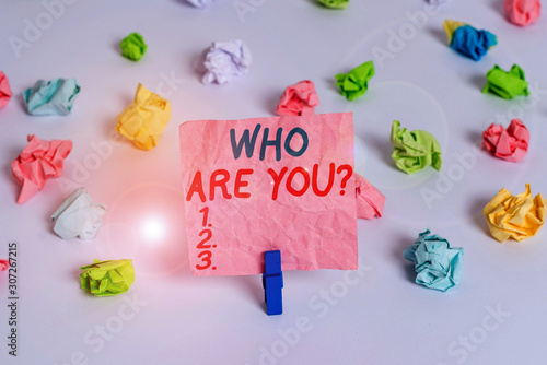 Conceptual hand writing showing Who Are You Question. Concept meaning asking about someone identity or demonstratingal information Colored crumpled paper empty reminder white floor clothespin