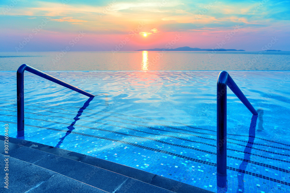 Swimming pool with stair and sunset background - obrazy, fototapety, plakaty 
