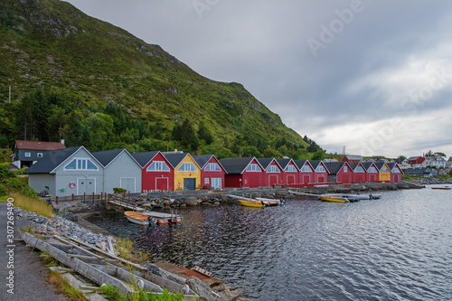 Alnes, Godoya, Norway. Red And Yellow Colorful Wooden Docks In Summer Day. Godoy Island Near Alesund Town. July 2019 photo