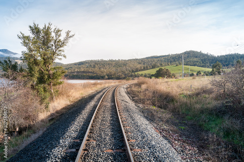 Railroad railing, railway going through countryside landscape