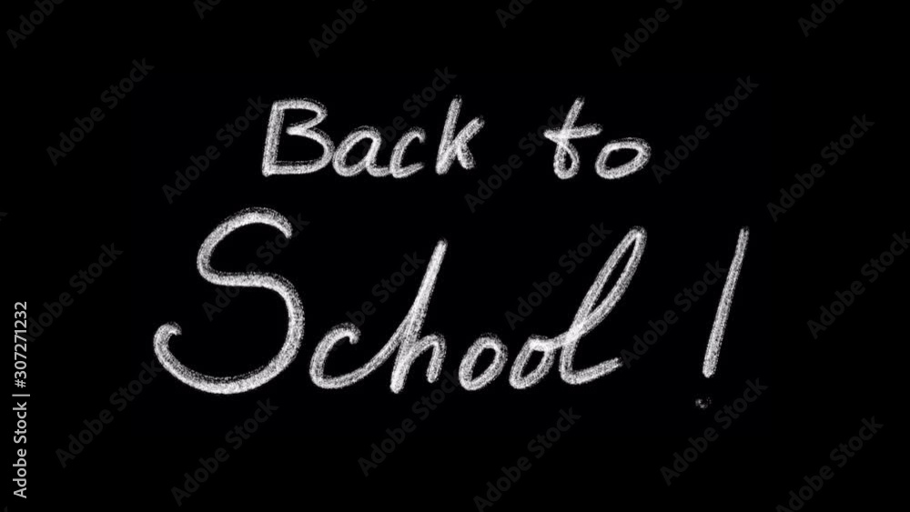 Back to school is being written in chalk isolated on black background for easy overlay Back to school is being written in chalk isolated on black background for easy overlay