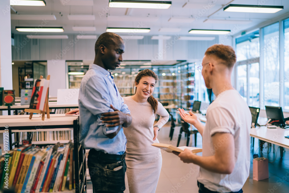 Obraz premium Cheerful students preparing for exam together