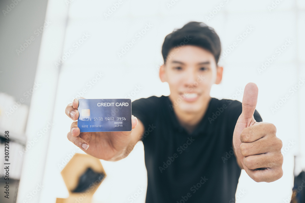 man hold credit card to camera, online marketing business concept man hold credit card to camera, online marketing business concept