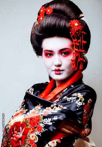 Obraz na płótnie young pretty geisha in black kimono among sakura, asian ethno close up on white