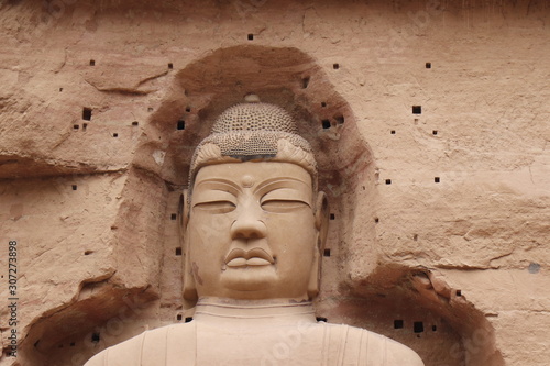 Buddha statue at Bingling Cave Temple in Yongjing, Gansu Province, China.UNESCO World heritage site.(Silk Roads: the Routes Network of Chang'an-Tianshan Corridor) photo
