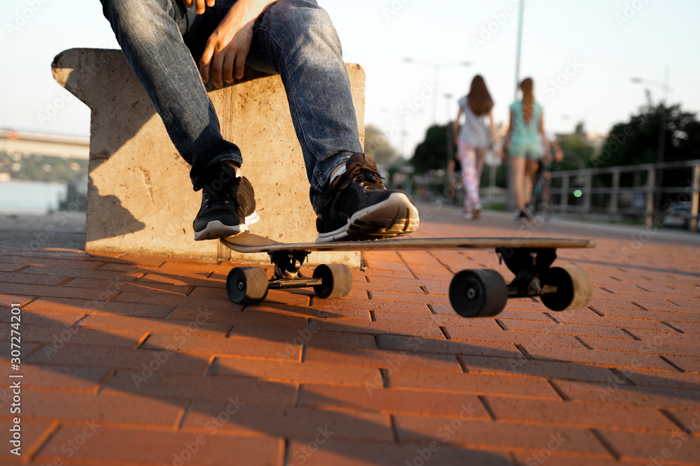 Closeup shot of unrecognizable man standing on long board Closeup shot of unrecognizable man standing on long board