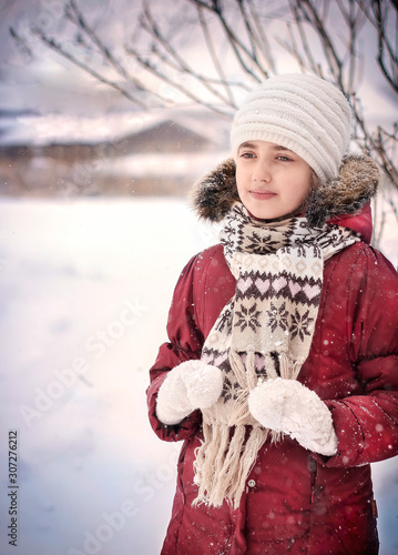 A child plays in the street in winter.