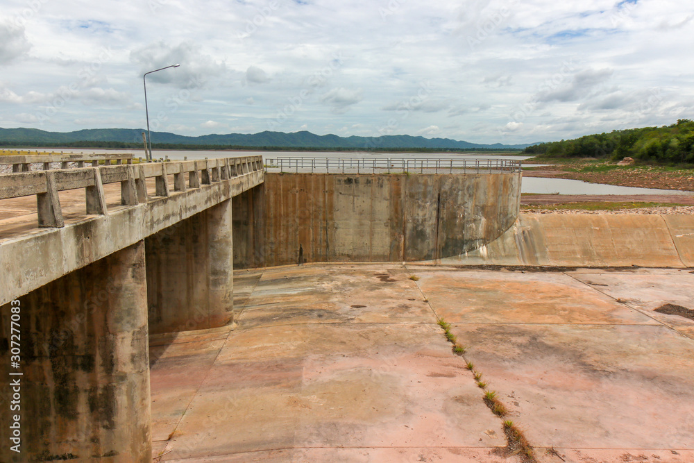 The dam crest the concrete spillway. countryside blocks the river to store water for agriculture and consumption