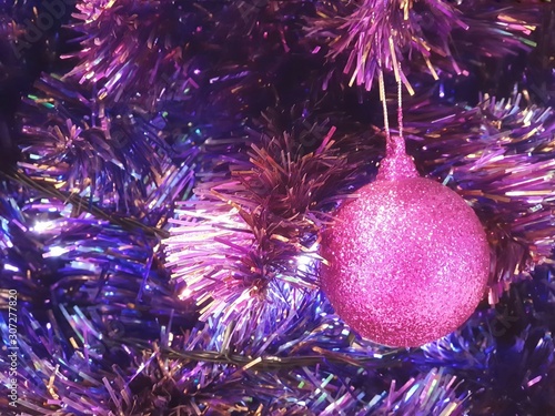 Christmas tree decorated with fancy pink christmas ball and beautiful ornaments.celebrate seasonal.garland background and xmas