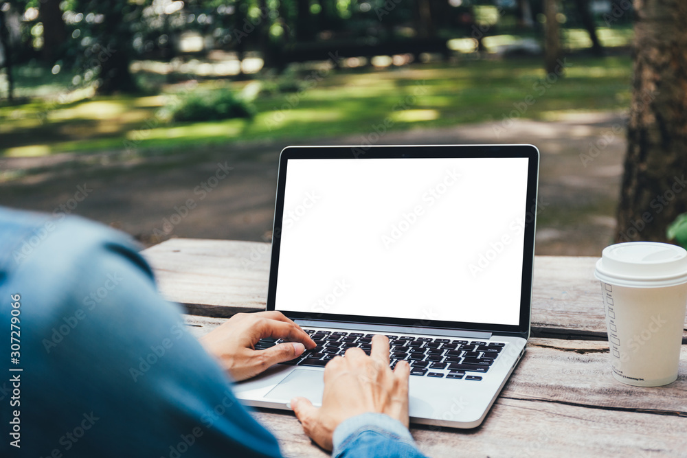 mockup image blank screen computer with blank white background for advertising text,hand man using laptop contact business search information on desk at home office.marketing and creative design mockup image blank screen computer with blank white background for advertising text,hand man using laptop contact business search information on desk at home office.marketing and creative design