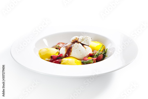 Exquisite serving burrata cheese with tomatoes and mango mousse