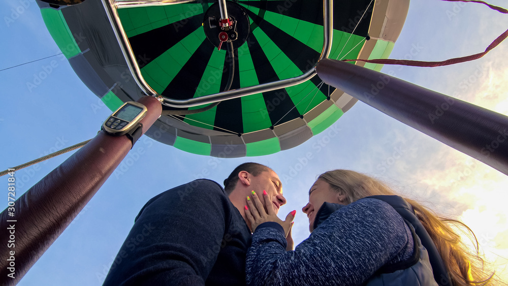 Adventure love couple on hot air balloon watermelon. Man and woman kiss ...