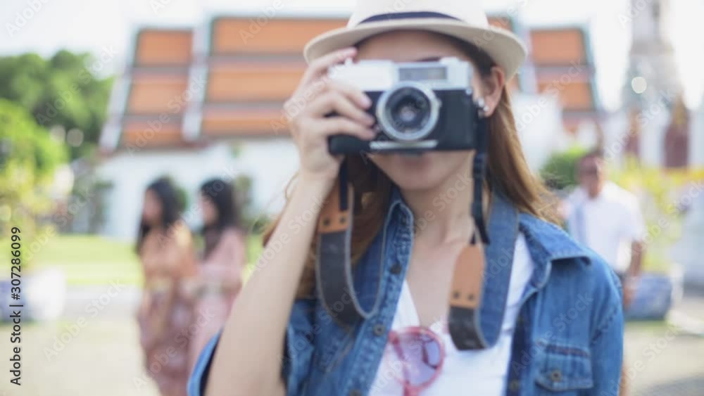 Traveler Asian travel in Bangkok, Thailand, Lifestyle travel in temple concept.Young fun happy Asian tourist backpacker travel and enjoy camera . Traveler Asian travel in Bangkok, Thailand, Lifestyle travel in temple concept.Young fun happy Asian tourist backpacker travel and enjoy camera .
