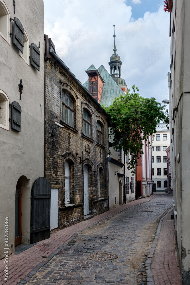 Narrow deserted street in the old town. Cathedral, Riga, Latvia.