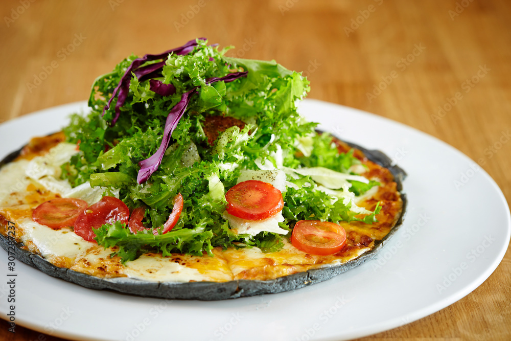 Black dough salad pizza with black pepper 