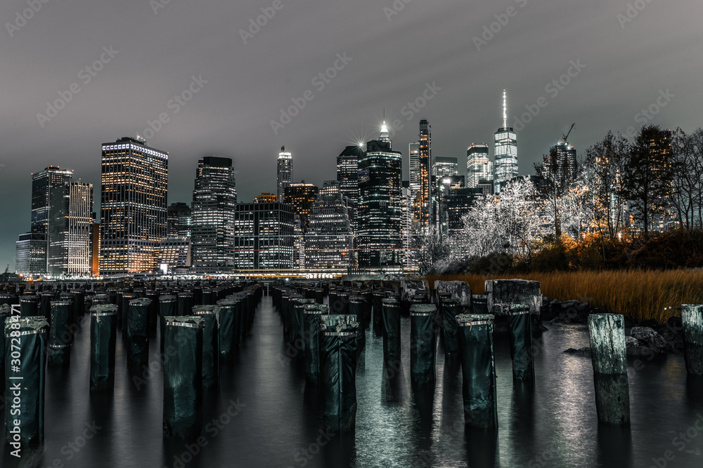 Long exposure old pier Brooklyn pylons looking out at downtown Manhattan