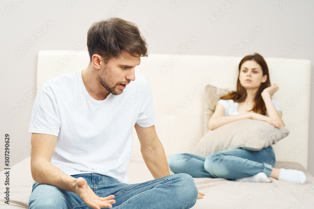 young couple sitting on sofa watching tv young couple sitting on sofa watching tv