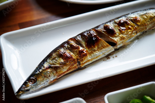 Grilled pacific saury fish on plate 