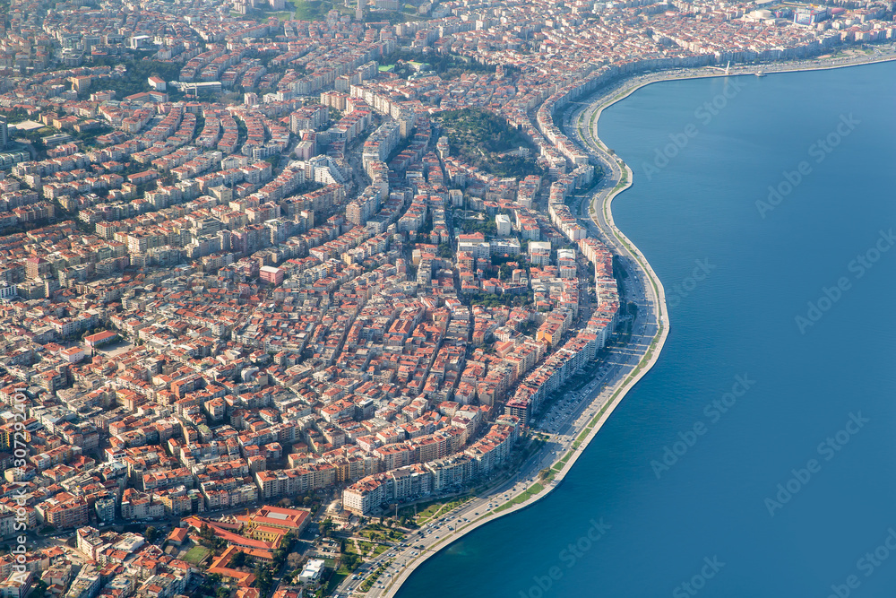 Fototapeta premium Passenger airplane flying over Izmir City