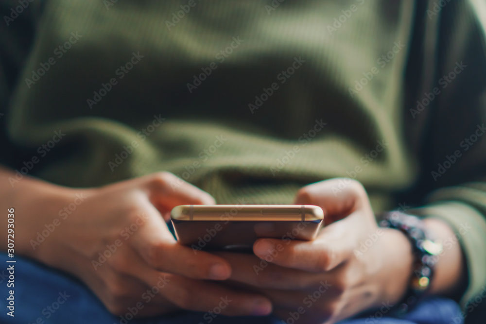 People hand using smartphone with blur cafe shop background. People hand using smartphone with blur cafe shop background.
