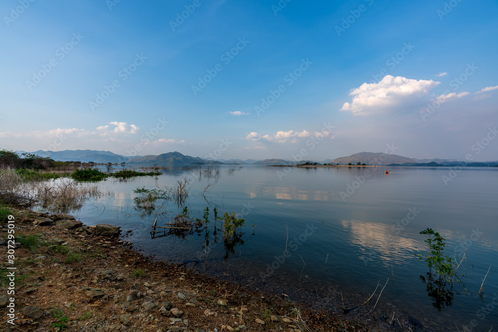 beautiful blue sky green forest mountains lake view at Kaeng Krachan National Park, Thailand.  an idea for backpacker hiking on long weekend or a couple, family activity camping holiday relaxing