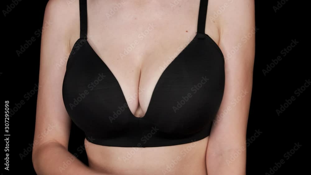 Woman Wearing A Black Bra And Crossing Her Arms With Black Background - Medium shot Woman Wearing A Black Bra And Crossing Her Arms With Black Background - Medium shot