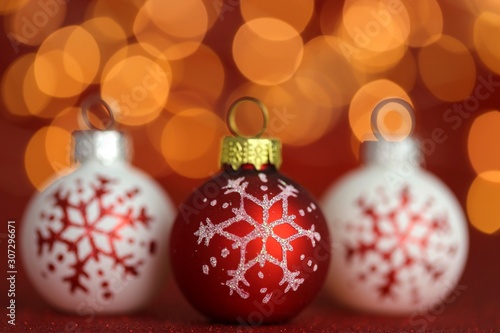 Christmas shiny wallpaper.Christmas festive background. christmas ball set with snowflake on red glitter background with yellow blurred bokeh.Winter holidays.