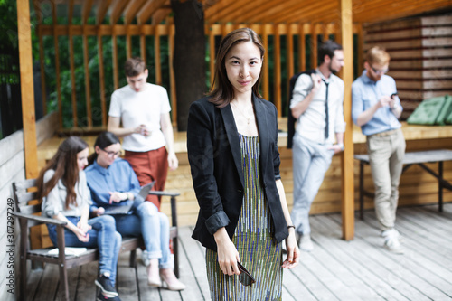 Portrait of an asian business woman over people background.