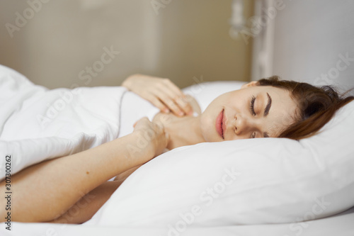 portrait of a woman lying on bed and looking at camera