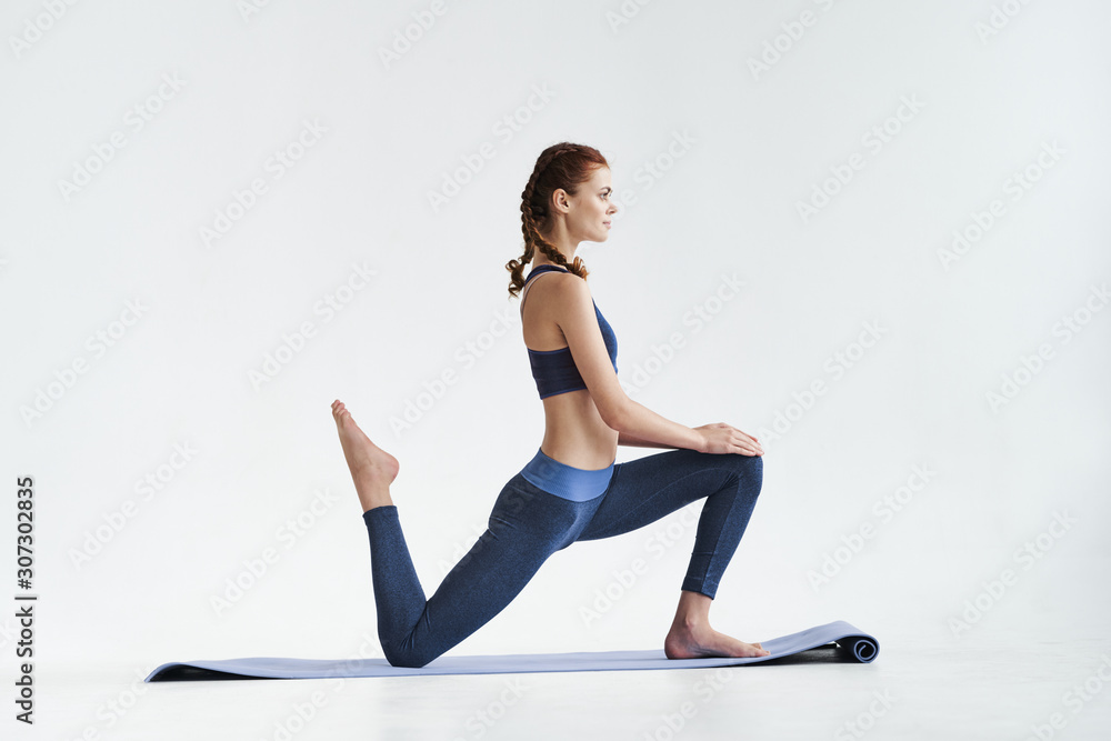 young woman doing stretching exercise at yoga