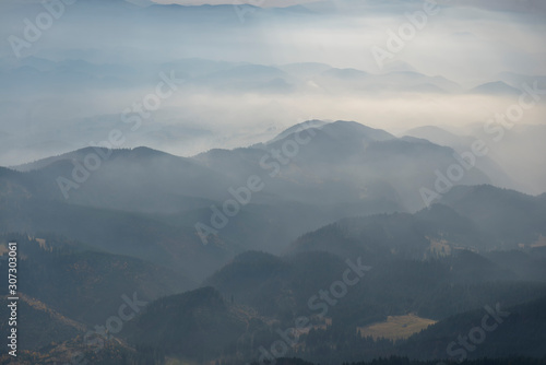 Foggy layered mountain landscape in Piatra Craiului mountains