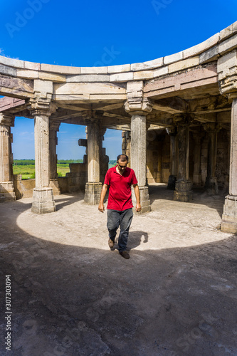 Young man exploring heritage Kabutar khana Pavilion also known as Khajuri mosque( masjid ) photo