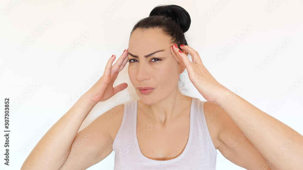 Headache concept - woman holding her head because of the headache Headache concept - woman holding her head because of the headache