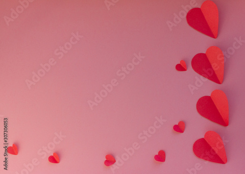 Hearts on a pink background. Valentin's Day, top view. Copy space. Flat lay. Greeting card.