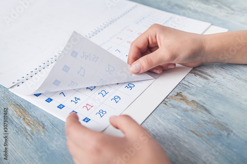 Girl holding calendar in the desk.