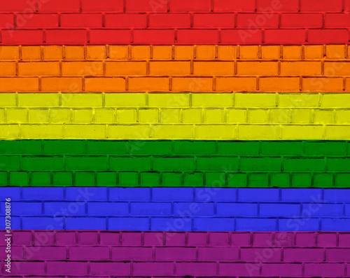 Brick wall texture with paint painted LGBT flag. Abstract multicolor graffiti.