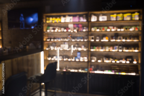 Blurry showcase in vape shop close up. Blurred showcase with the goods.