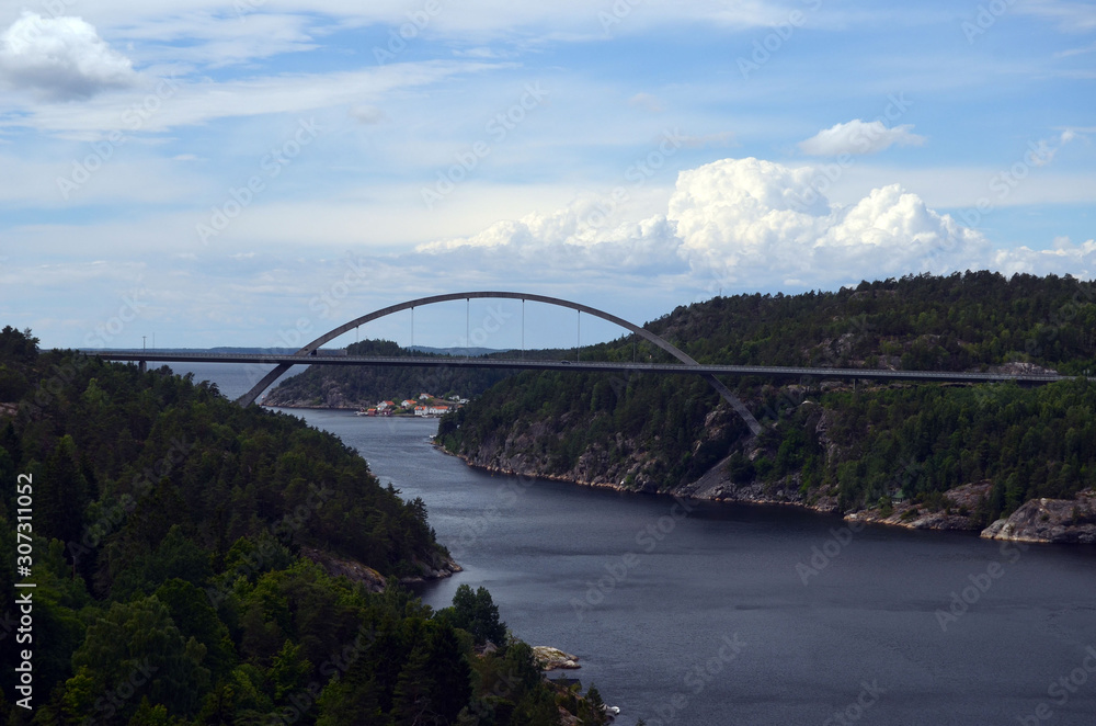 Typical Swedish nature and houses on the shore of the fjord. View from the high bridge over the fjord. The border of Norway and Sweden.Near the town Selater,Sweden