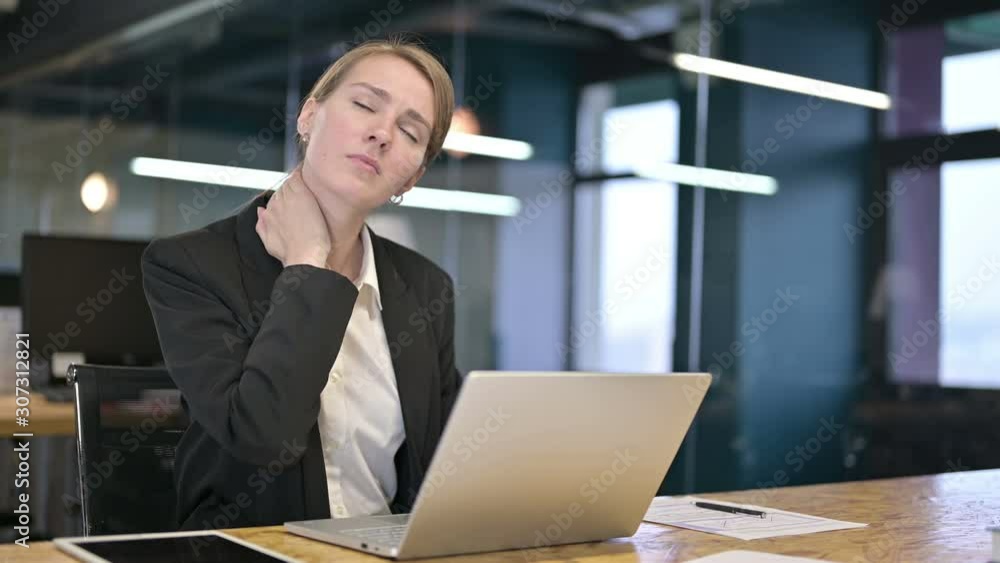 Hardworking Young Businesswoman having Neck Pain in Office Hardworking Young Businesswoman having Neck Pain in Office